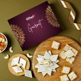 Giftechs Gourmet box with cookies on a wooden board and bowl of nuts on a green background